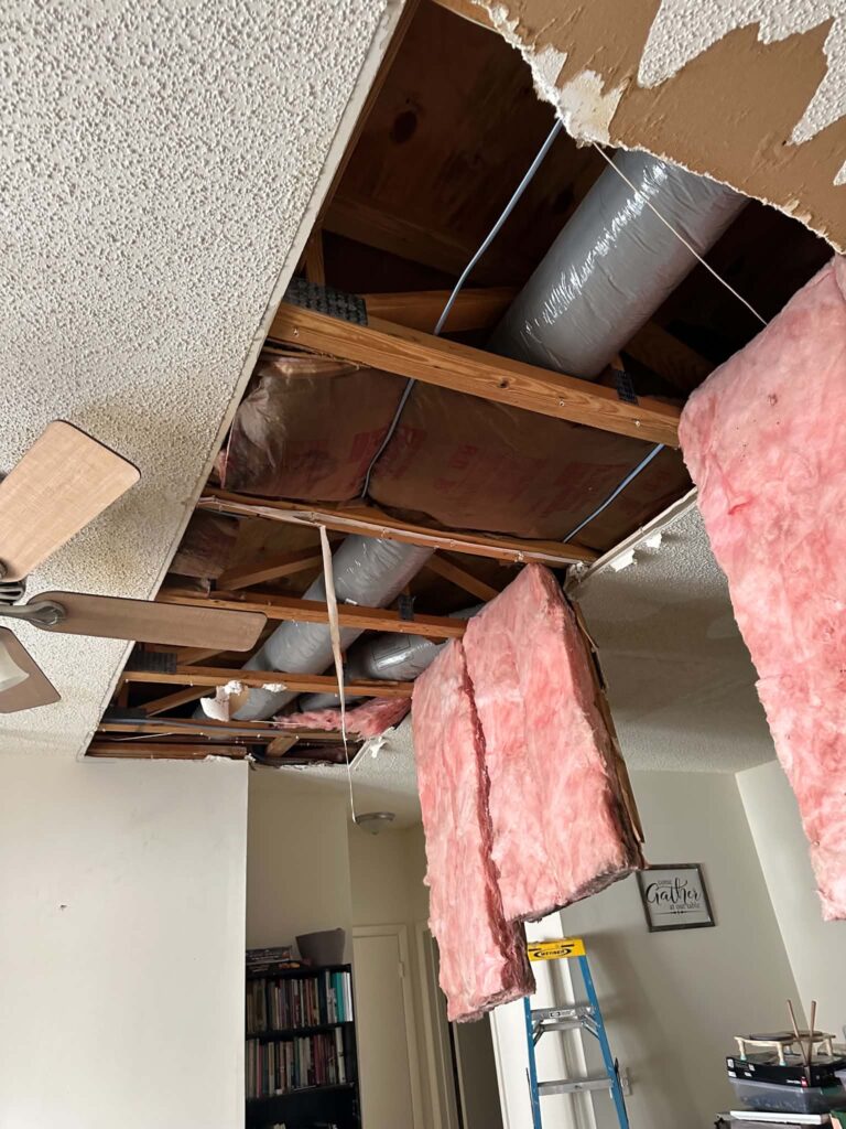 Caved in ceiling from flood damage in a downstairs apartment